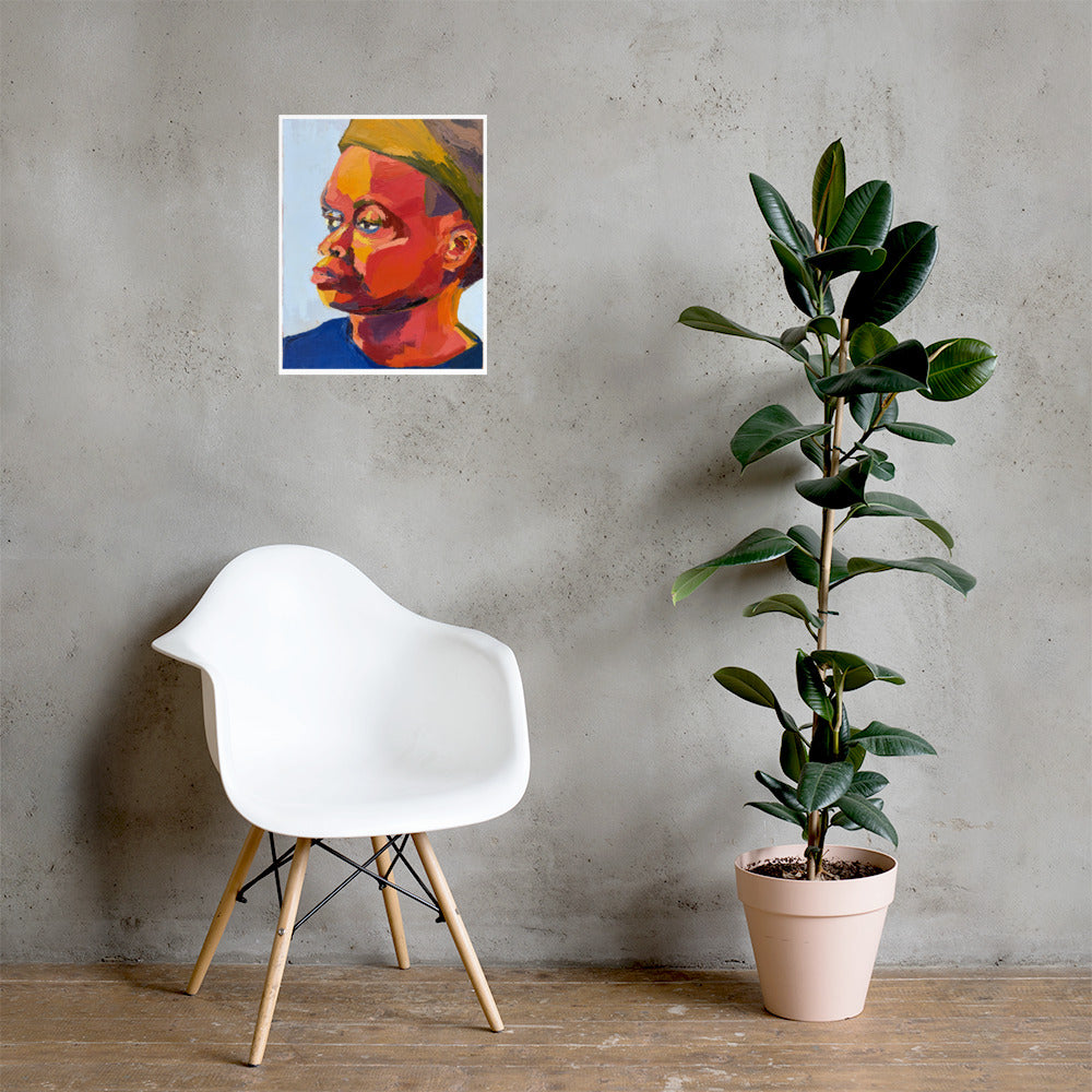 Mock-up of a colorful textured portrait painting hanging on a light gray wall, above a white chair, and next to a tall green plant. 