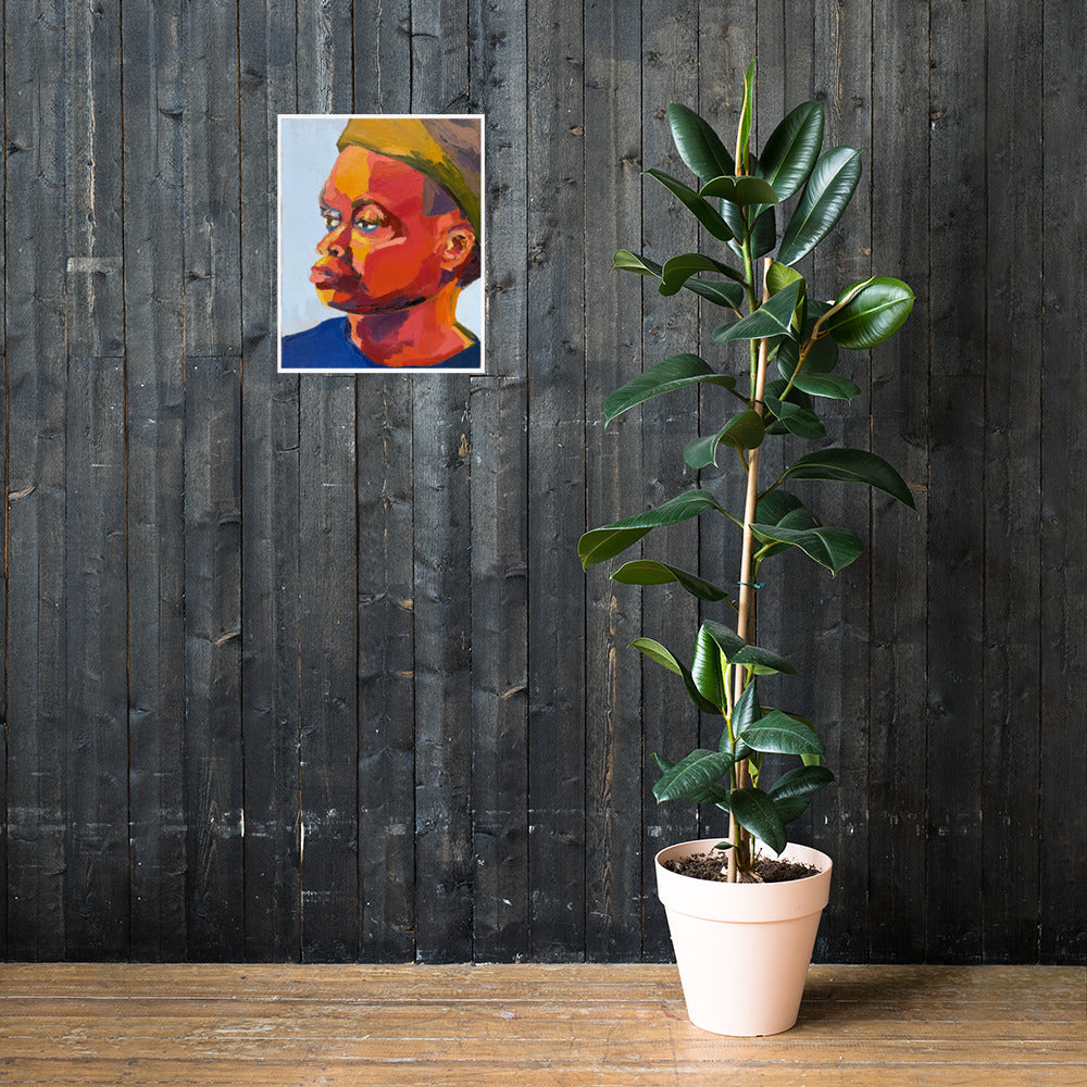 Mock-up of a colorful textured portrait painting hanging on a dark gray wall next to a tall green plant. 